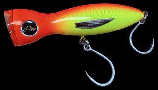 A crankbait fishing lure with a bright orange, yellow, and neon green gradient body, featuring a black side stripe and two silver metal hooks.