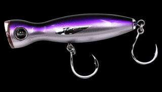 A metallic purple and silver fishing lure with two treble hooks, shown against a plain white background.