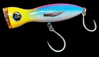 A multicolor crankbait fishing lure with a yellow, blue, and pink gradient body, featuring a black and white circular logo on the side and two silver metal hooks.